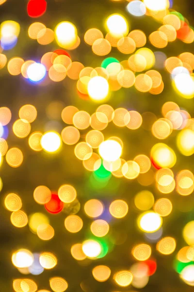 Desenfocado árbol de navidad luces en un fondo de la ciudad — Foto de Stock