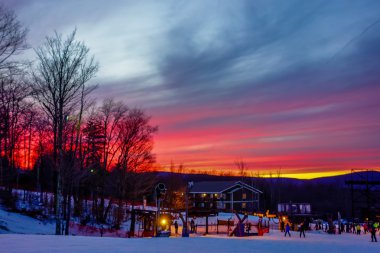 fiery sky at sunset over timberline ski resort west virginia clipart