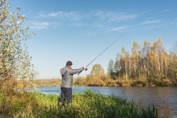 Homem Está Costa Com Uma Vara Pesca Pescador Uma Jaqueta — Fotografia de Stock