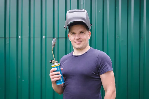 Portrait of a happy man with a welder mask.