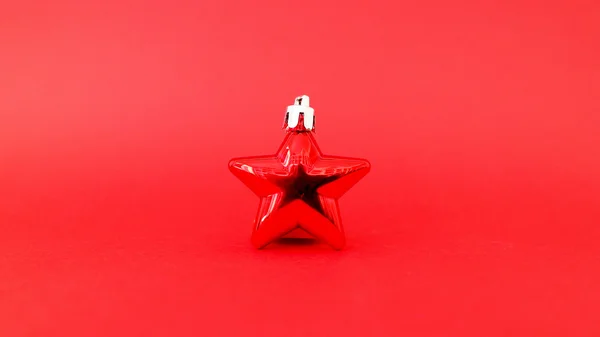 Red christmas star with a red background — Stock Photo, Image