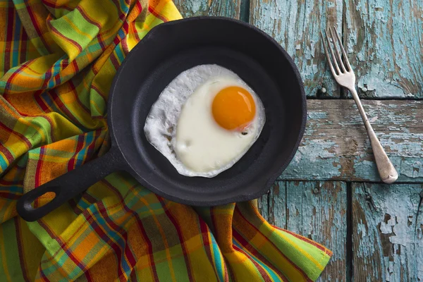 Iron pan on old wooden table