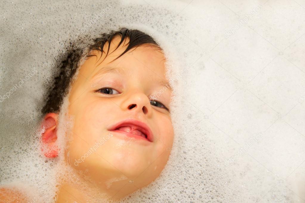 happy baby face in bubble bath