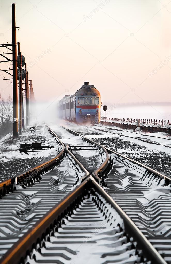 Passenger train rapidly moving along the snow track