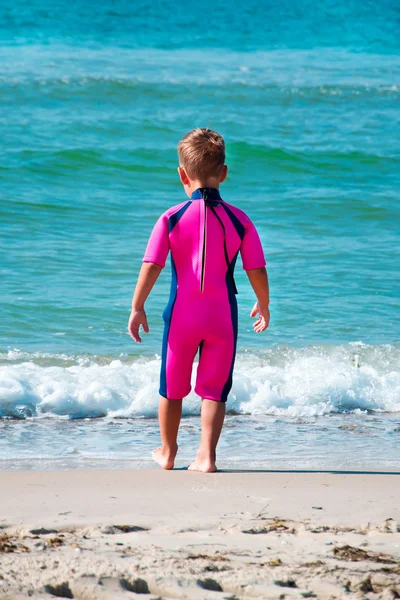 Small boy wearing diving suit going in sea — Stock Photo, Image