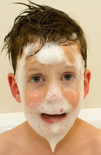 Le garçon avec la barbe de mousse dans la salle de bain — Photo