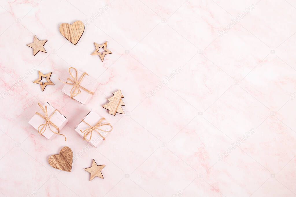 Assortment of Scandinavian style, eco friendly, handmade Christmas decorations and presents on pink marble background, flat lay, top view with copy space