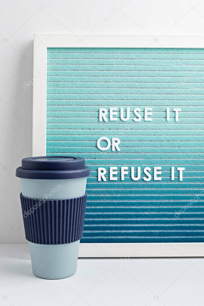 Reusable coffee cup and letterboard with text reuse it or refuse it. Zero waste sustainable lifestyle. Eco friendly habbits for take away coffee