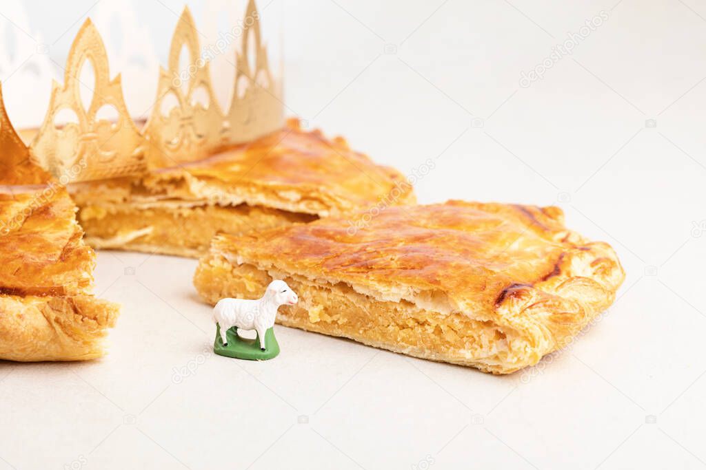 King cake or galette des rois in French. Traditional epiphany pie with golden paper crown and tiny charms