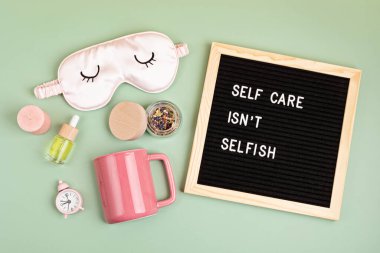 Self care is not selfish. Felt letter board with sleep optimization products, concept of rest, quality of sleep, good night, insomnia, relaxation. Flat lay, top view clipart