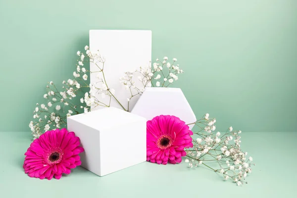 Podium, stand for product presentation and spring flowers. Mockup for branding, packaging