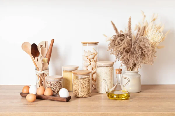 Assortment of cereals and pasta in glass jars and woden kitchen utensils. Zero waste idea — Stock Photo, Image