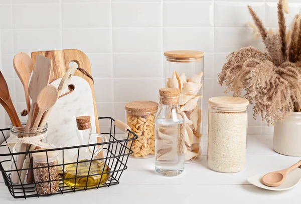 Assortment of cereals and pasta in glass jars and woden kitchen utensils. Zero waste idea — Stock Photo, Image