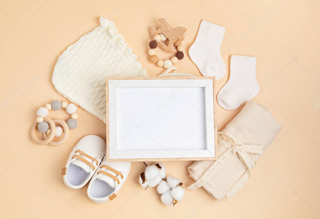 Mockup of empty frame with eco friendly baby accessories. Baby shower invitation, greeting card. Template for brand, logo, advertising. Flat lay, top view