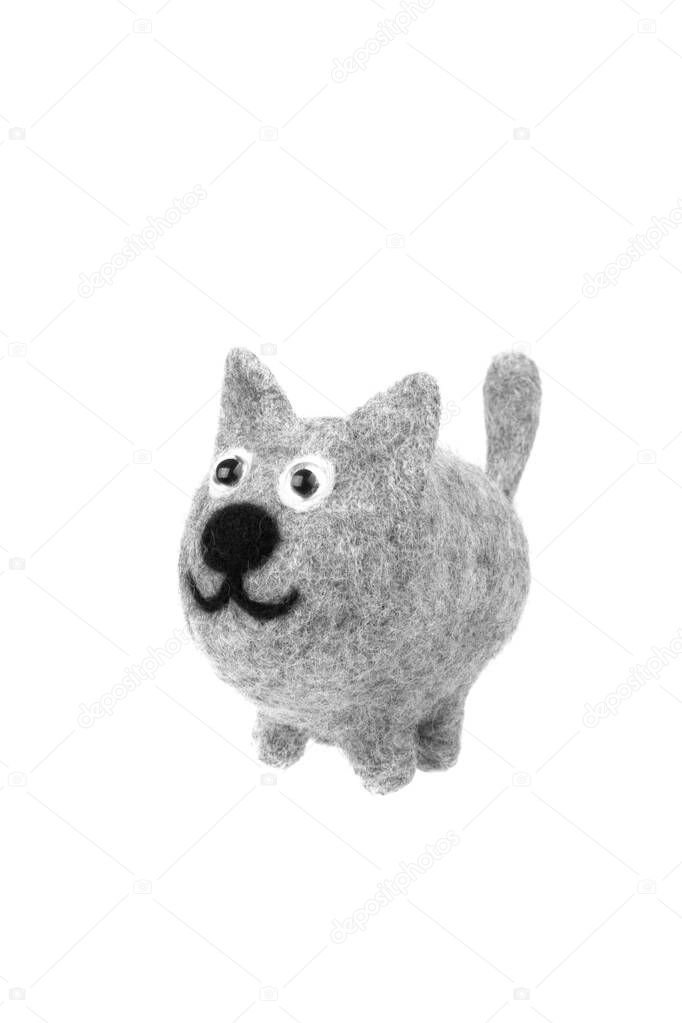 Toy gray cat isolate on a white background. Toy kitten made of felted wool.