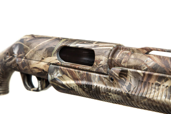 Macro view of the camouflage shotgun's receiver and ejection port, isolated on white.