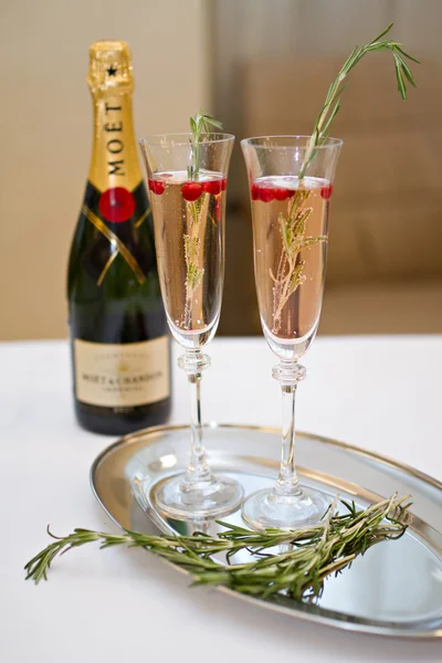 Two glasses of Champagne and rosemary branch on a table — Stock Photo, Image