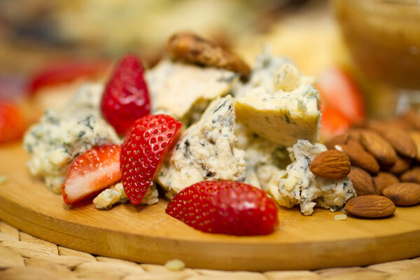 Still life picture with cheese and strawberries