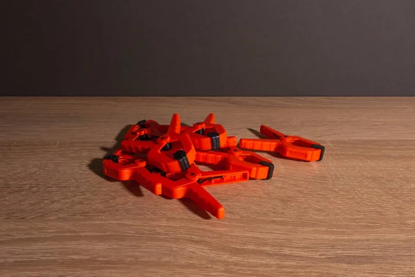 Clothespins Carpentry Clamps Orange Color Lie Wooden Table — Stock Photo, Image