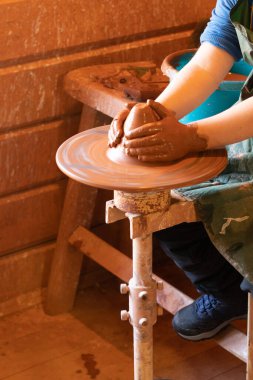 Potter 'ın elleri. Çömlekçi çarkında kil ürünleri yapmak. Çömlek ustası sınıfı.