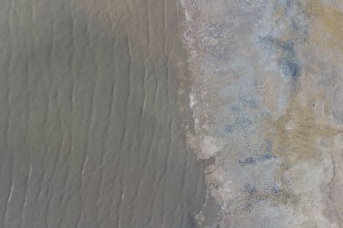 Kuyalnik nehrinin yüzeyinde taş bir tükürük ve tahta sütunlar. Helikopter görünümü