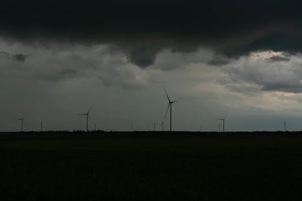 A wind farm from several wind turbines in a thunderstorm. Thunder Sky