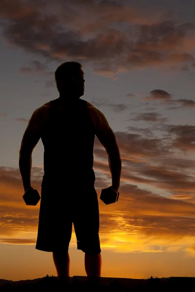 Silueta del hombre haciendo ejercicio al aire libre —  Fotos de Stock