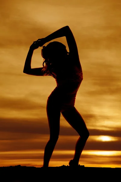 Silhouette femme en maillot de bain rose lève les bras — Photo