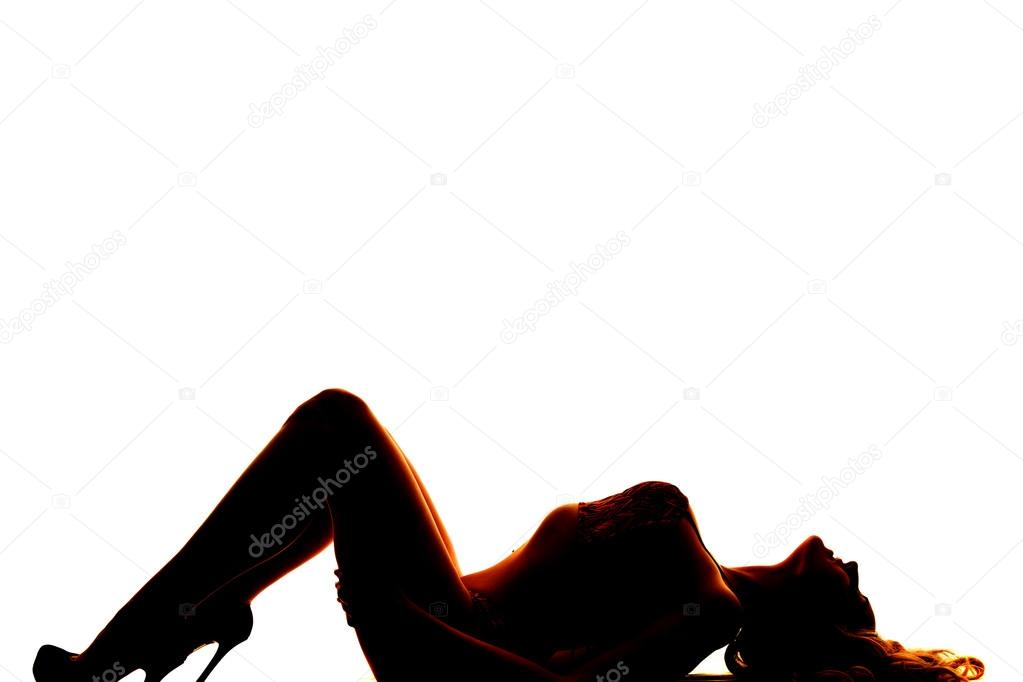 silhouette of woman in bikini lay on back knees up