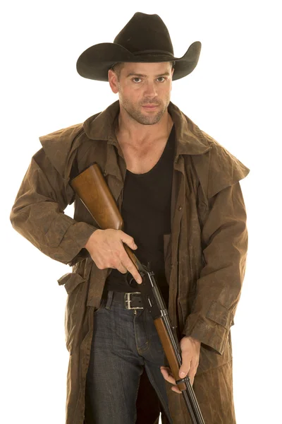 Cowboy in black hat and duster hold rifle look — Stock Photo, Image