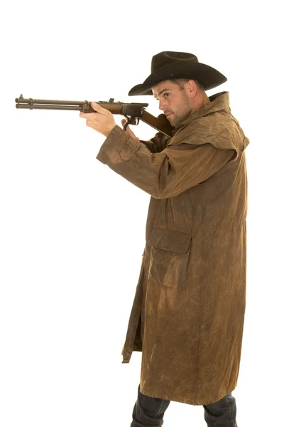 Cowboy in black hat and duster aim rifle — Stock Photo, Image