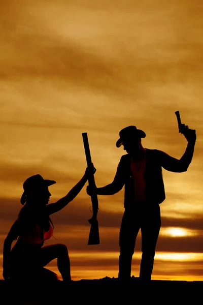 Silhouette of cowgirl and cowboy grab gun — Stock Photo, Image