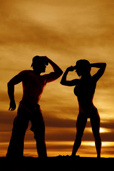 Silhouette of woman in bikini and hat hands up cowboy — Stock Photo, Image