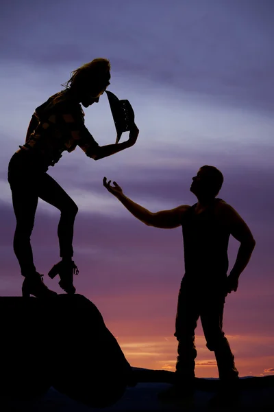 Silhouette of man hand reaching up to a woman — Stock Photo, Image