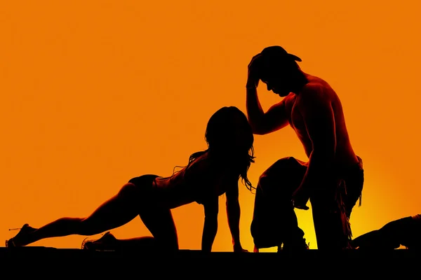 Silhouette off sexy woman crawling leg bak cowboy on knee — Stock Photo, Image