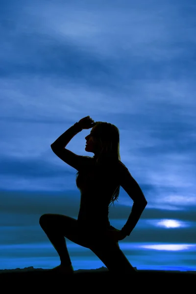 Silhouet van de vrouw op één knie hand aan hoofd kant — Stockfoto