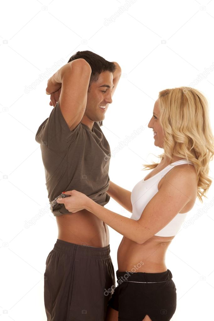 woman take off mans shirt facing smiling