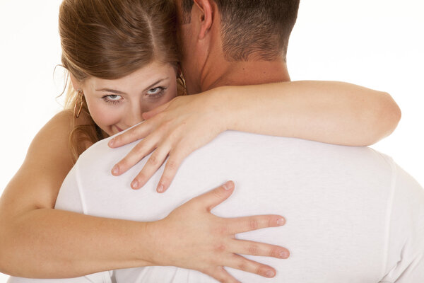 woman arms around man close she looks