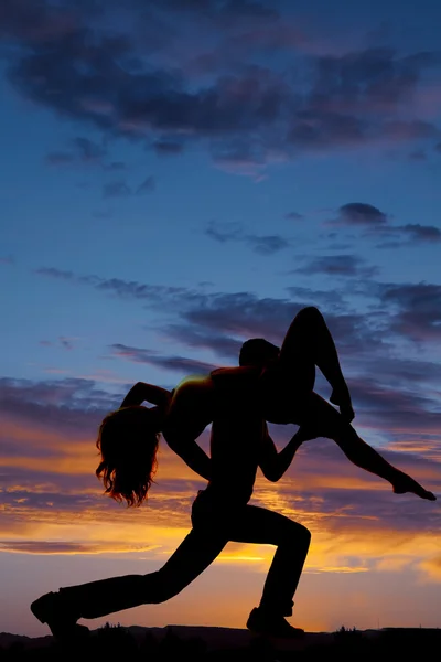 Silhouettes of man holding woman on shoulder — Stock Photo, Image