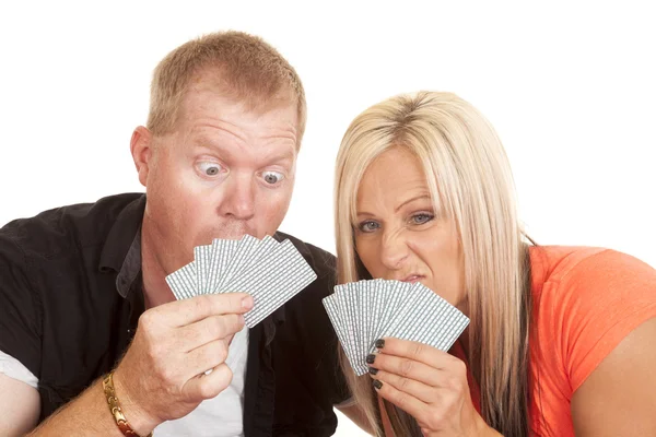Man and woman funny expression behind playing cards — Stock Photo, Image
