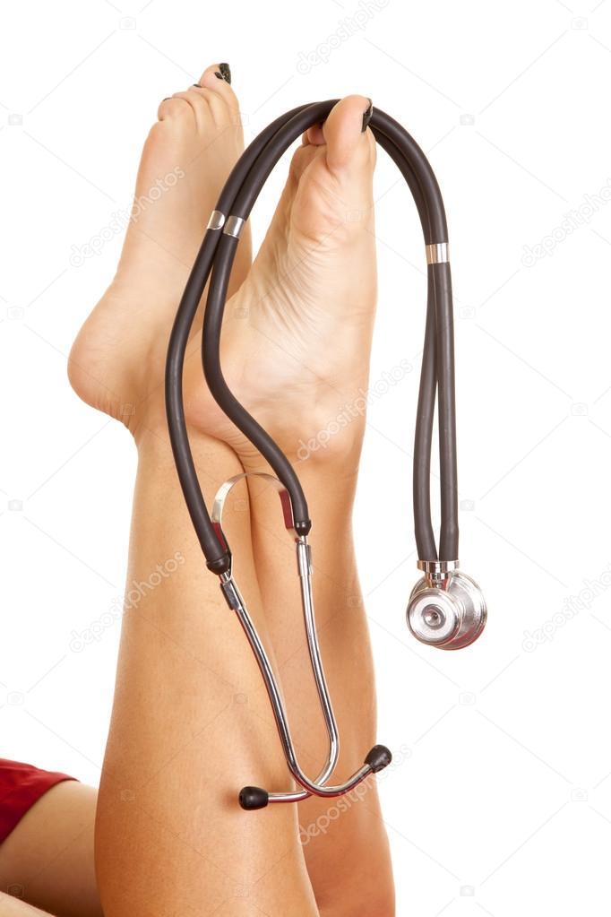 Female legs up with a stethoscope on toes