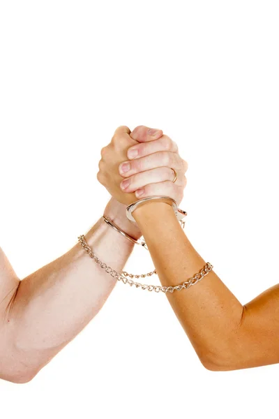 Handcuffs around arms. — Stock Photo, Image