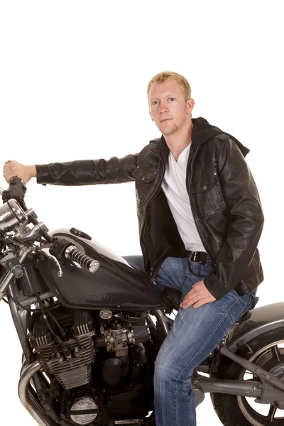 Man in black jacket motorcycle on hand on handlebars looking — Stock Photo, Image