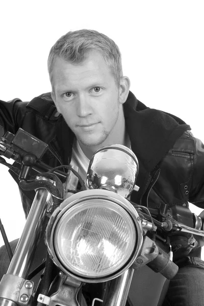 Man on motorcycle black jacket lean forward facing close bw — Stock Photo, Image