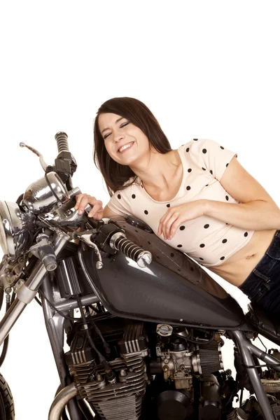 Woman on a motorcycle gas tank smiling — Stock Photo, Image