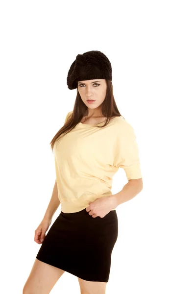 Woman yellow shirt black hat stand side serious — Stock Photo, Image