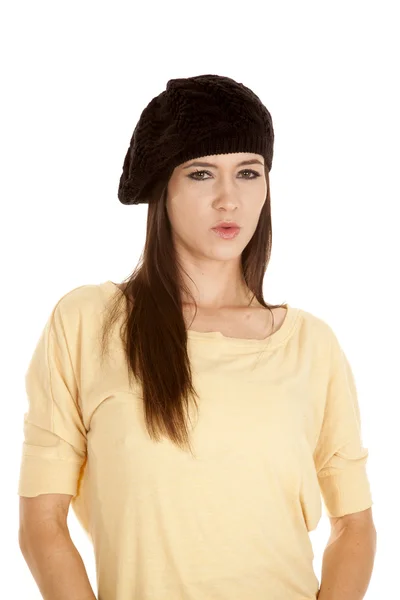 Woman yellow shirt black hat serious look — Stock Photo, Image