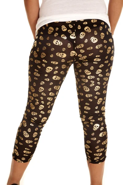 Woman in black with gold skulls leggings. — Stock Photo, Image