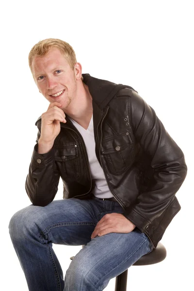 Man black jacket sit hand on chin smile — Stock Photo, Image