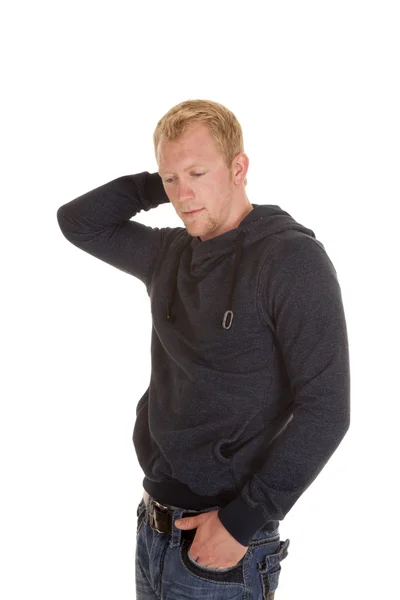 Man in a hoodie hand on back of head one in pocket — Stock Photo, Image